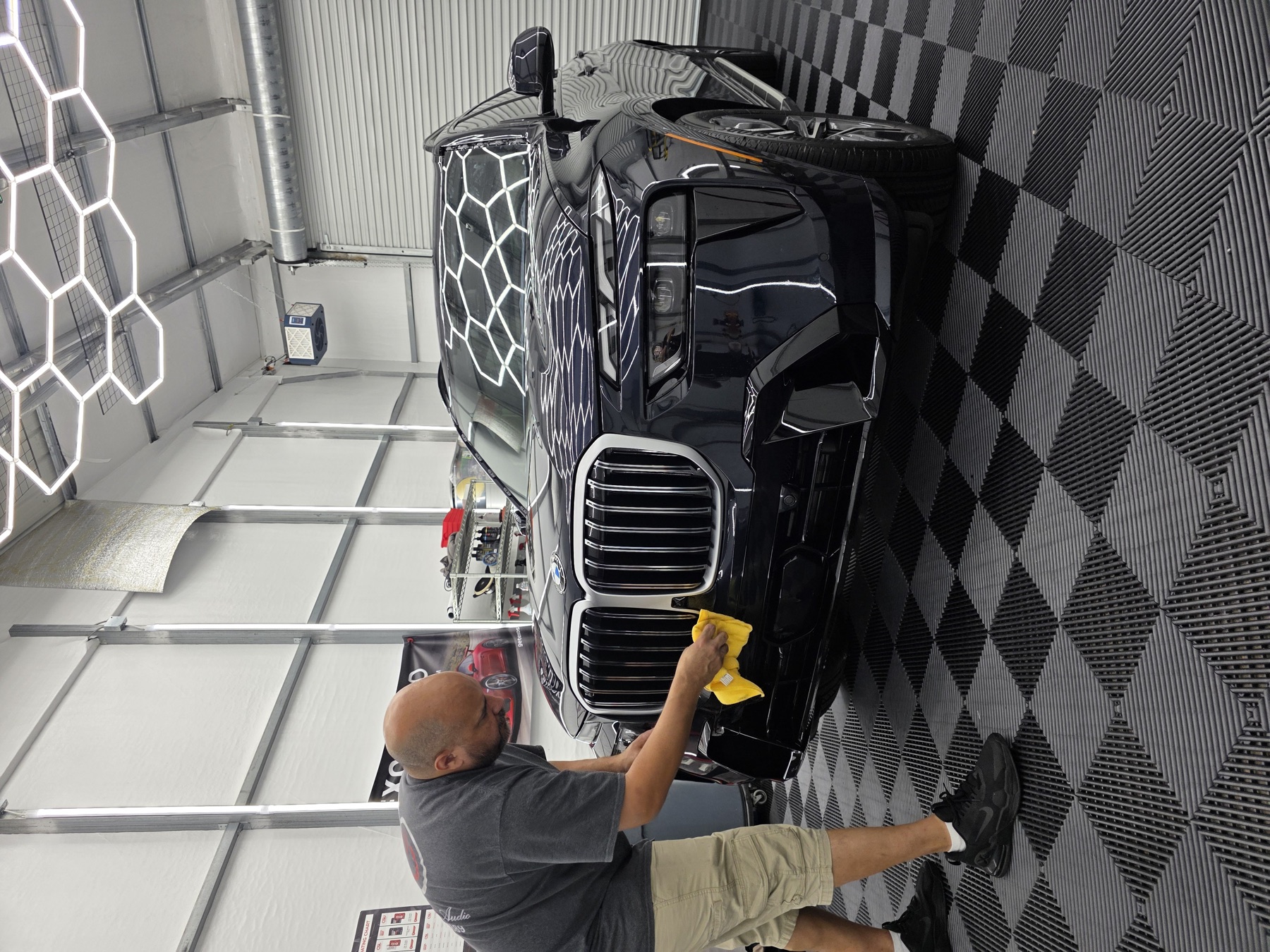 Certified technician finishing work in the Extreme Car Audio install bay